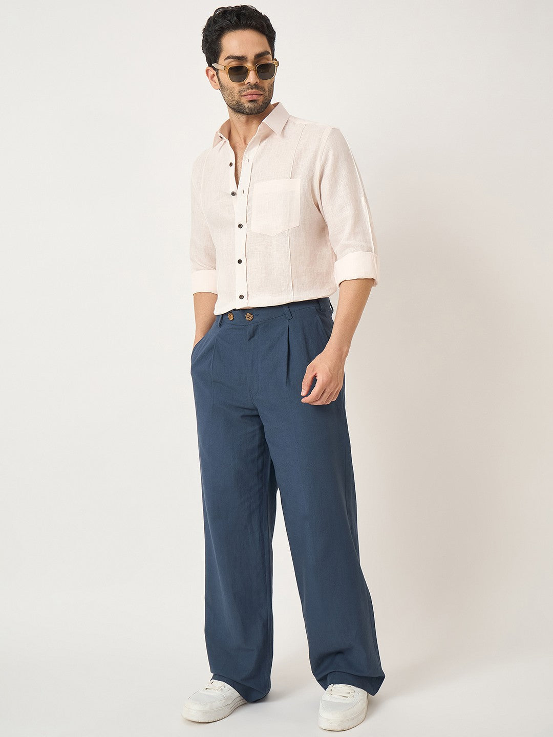 Man wearing a white shirt and blue pants on a white background