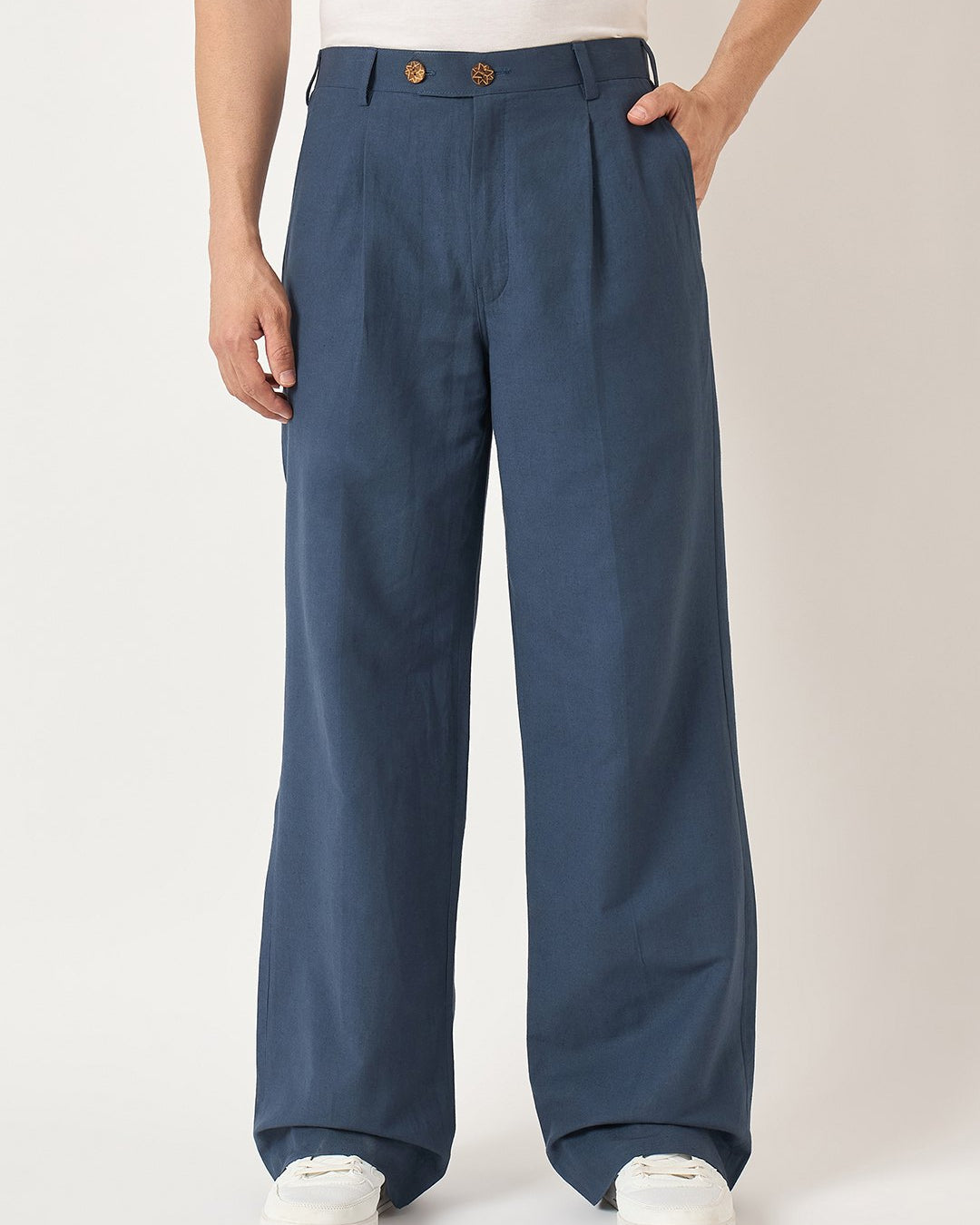 Person wearing blue wide-leg pants on a plain background