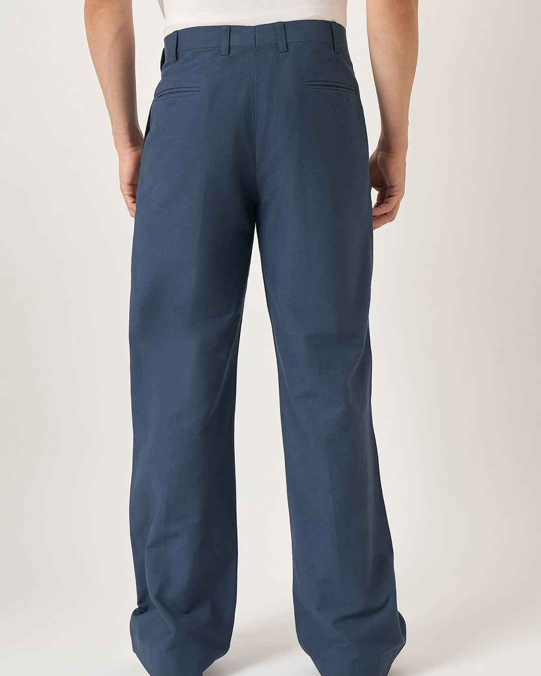 Blue pants worn by a person on a white background