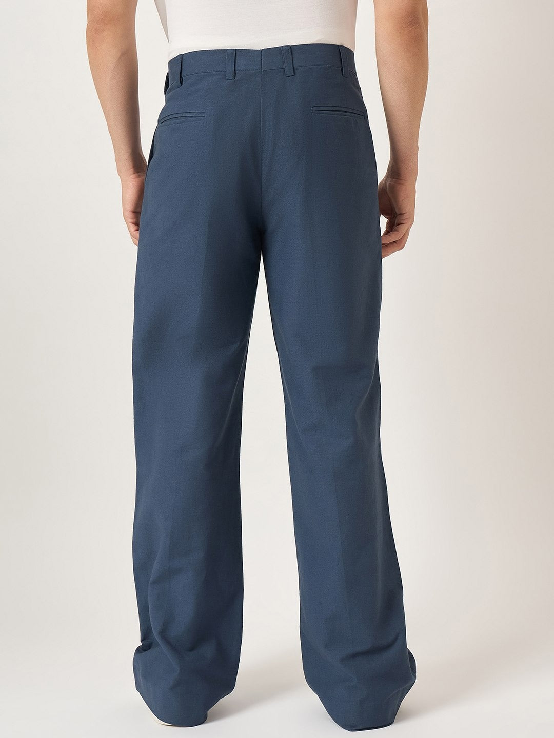 Blue pants worn by a person on a white background