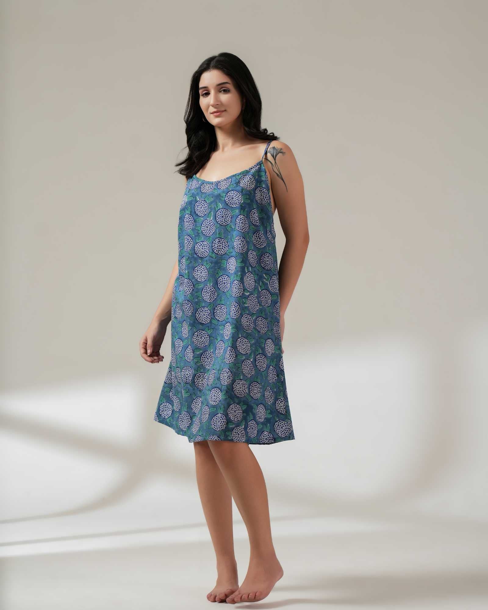 Woman wearing a blue patterned dress on a white background