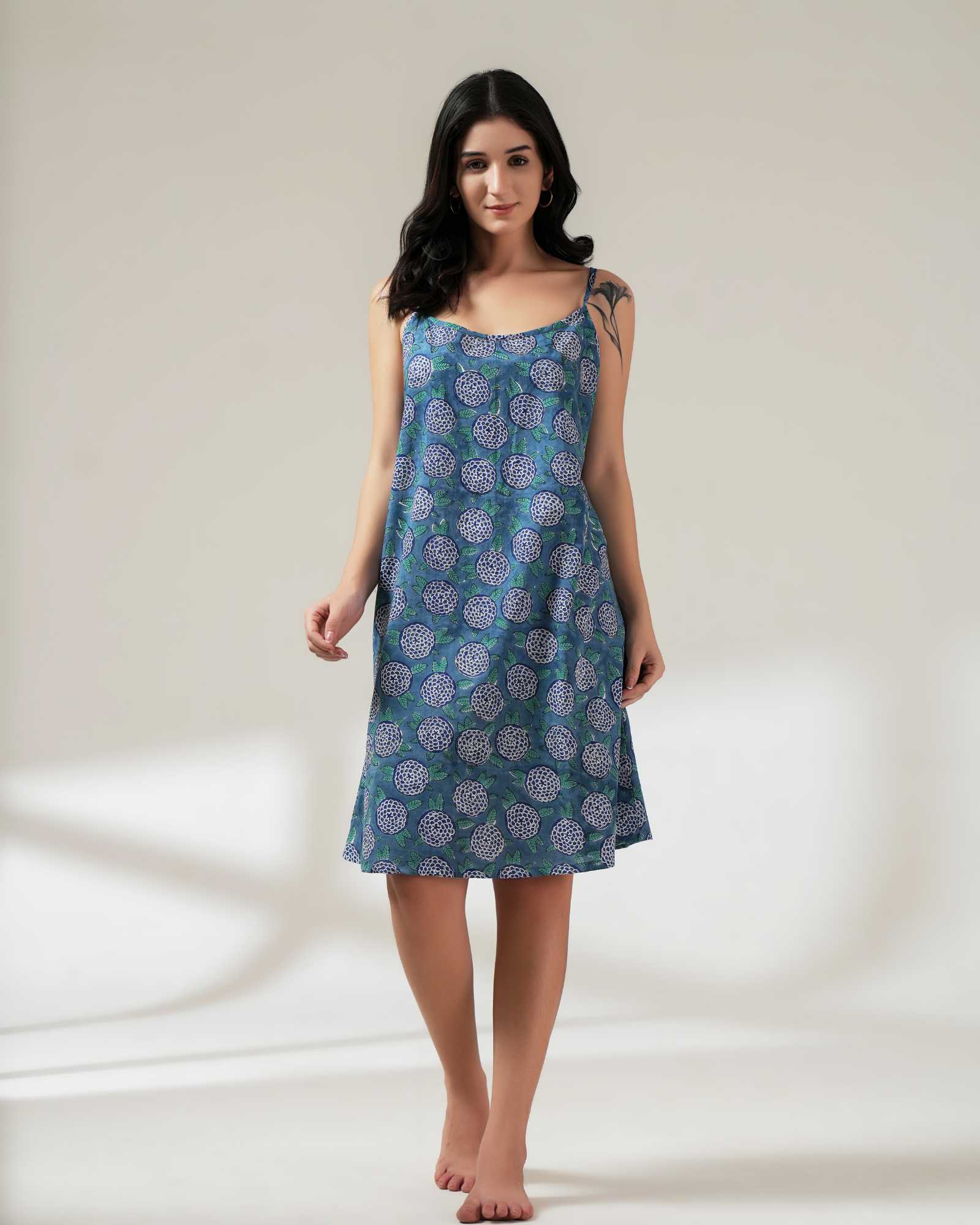 Woman wearing a blue patterned dress on a white background