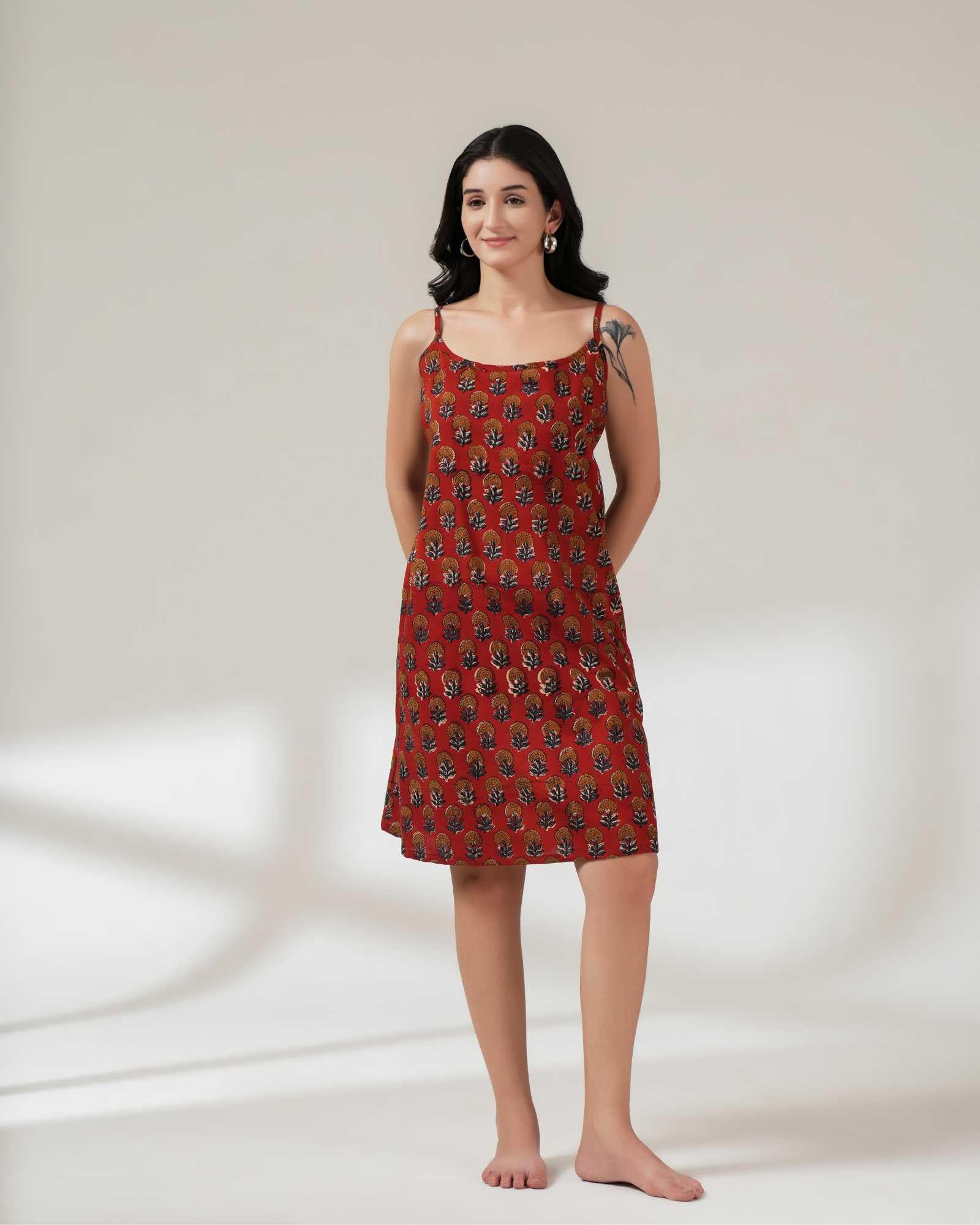Woman wearing a red patterned dress on a white background