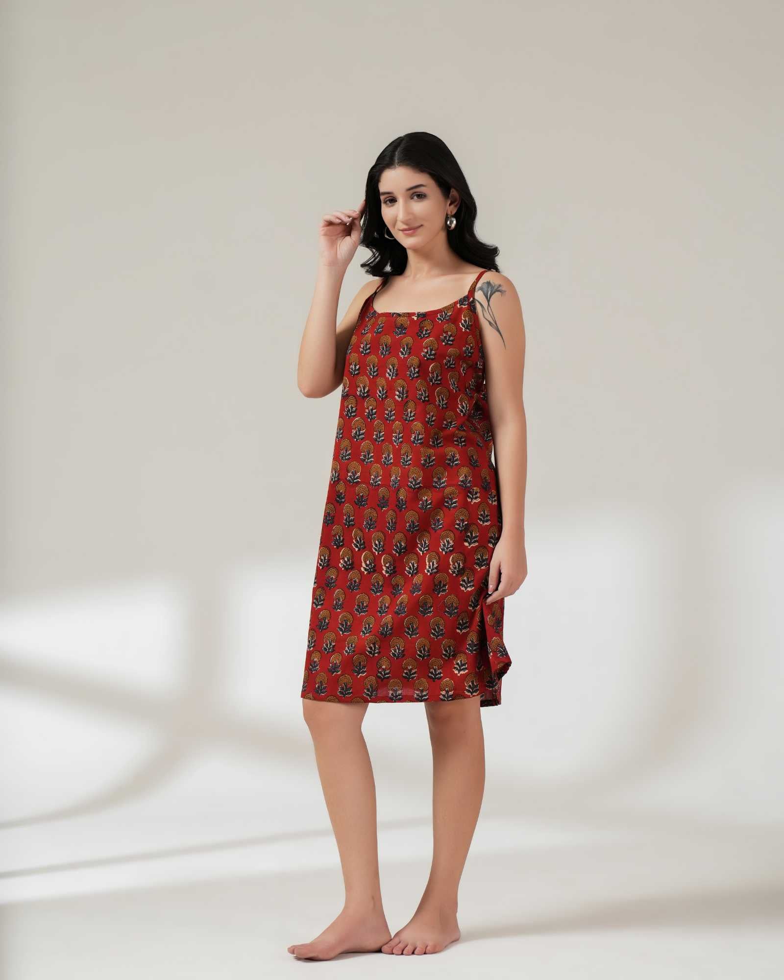Woman wearing a red patterned dress on a white background