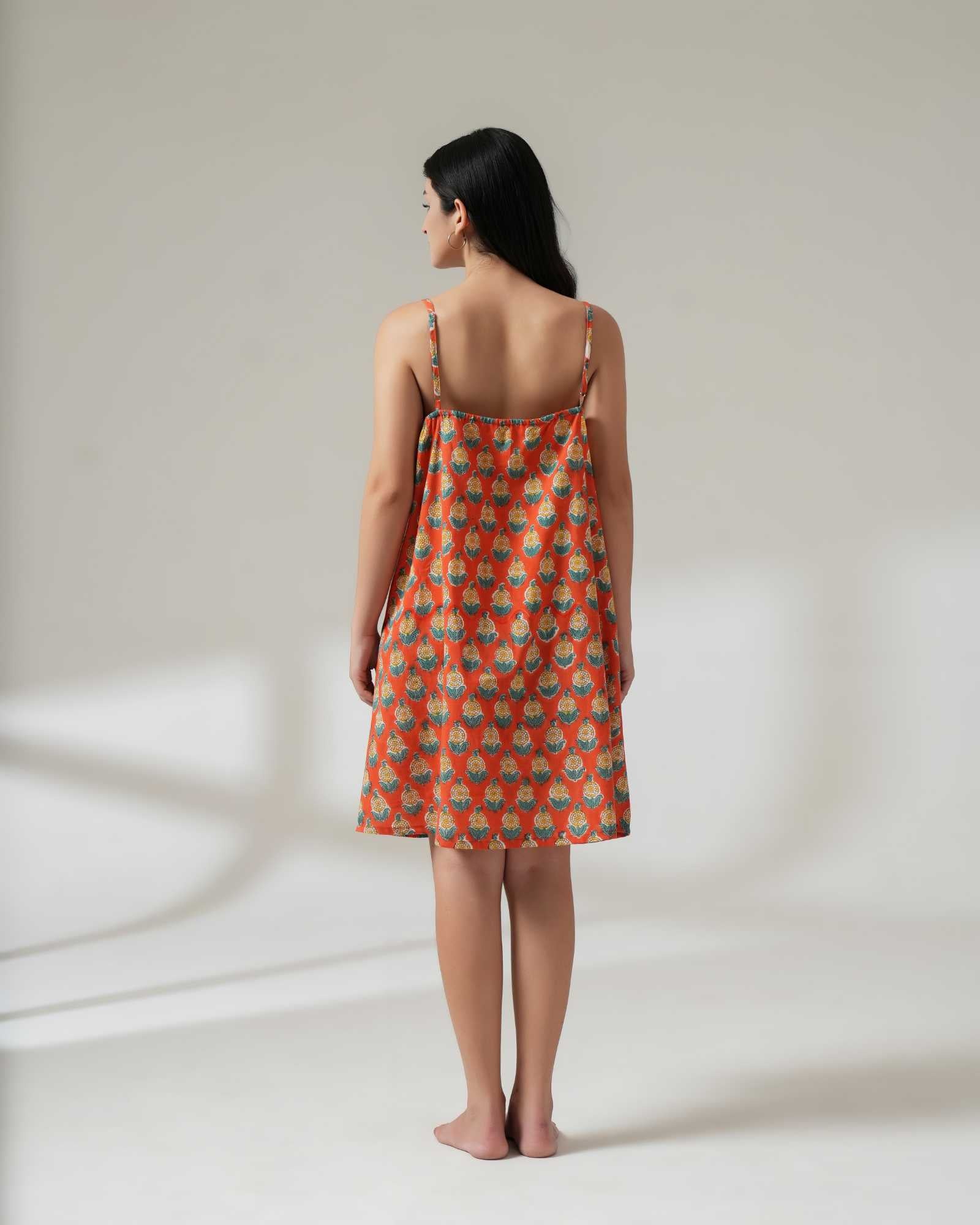 Woman wearing a red patterned dress on a white background