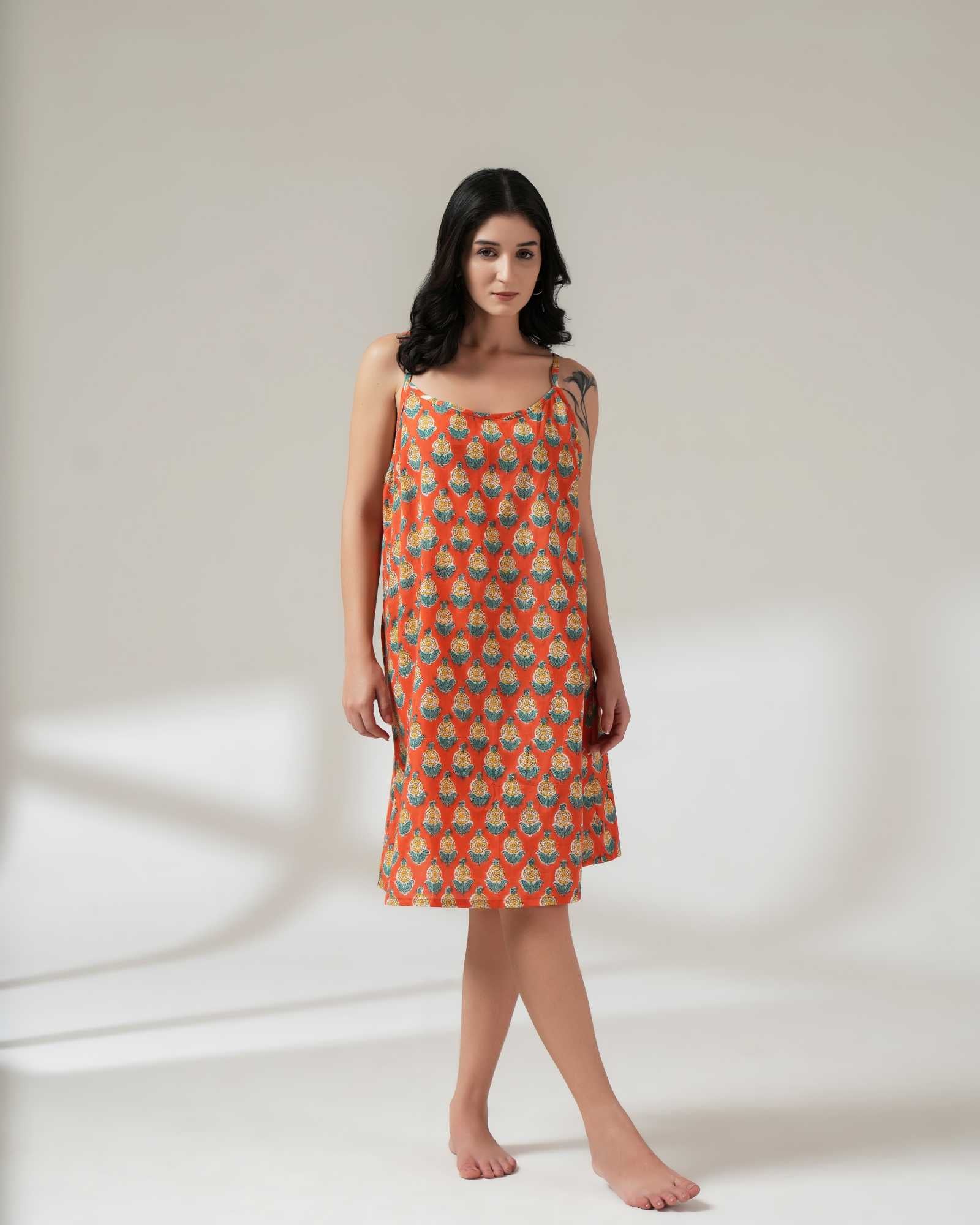 Woman wearing a patterned dress on a plain background
