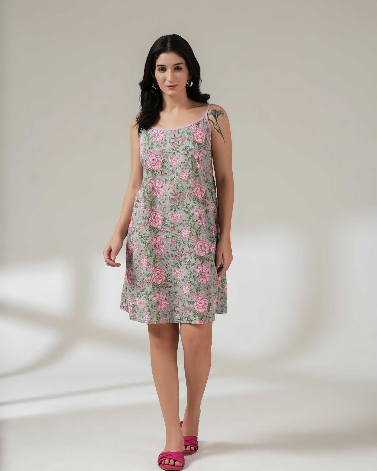Woman wearing a floral dress on a plain background