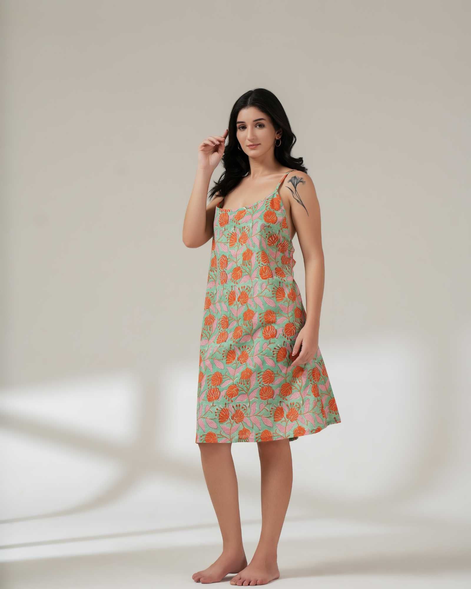 Woman wearing a floral dress on a plain background