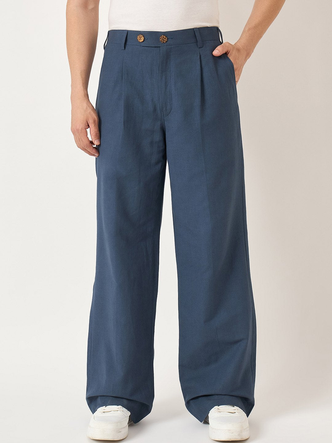 Person wearing blue wide-leg pants on a plain background