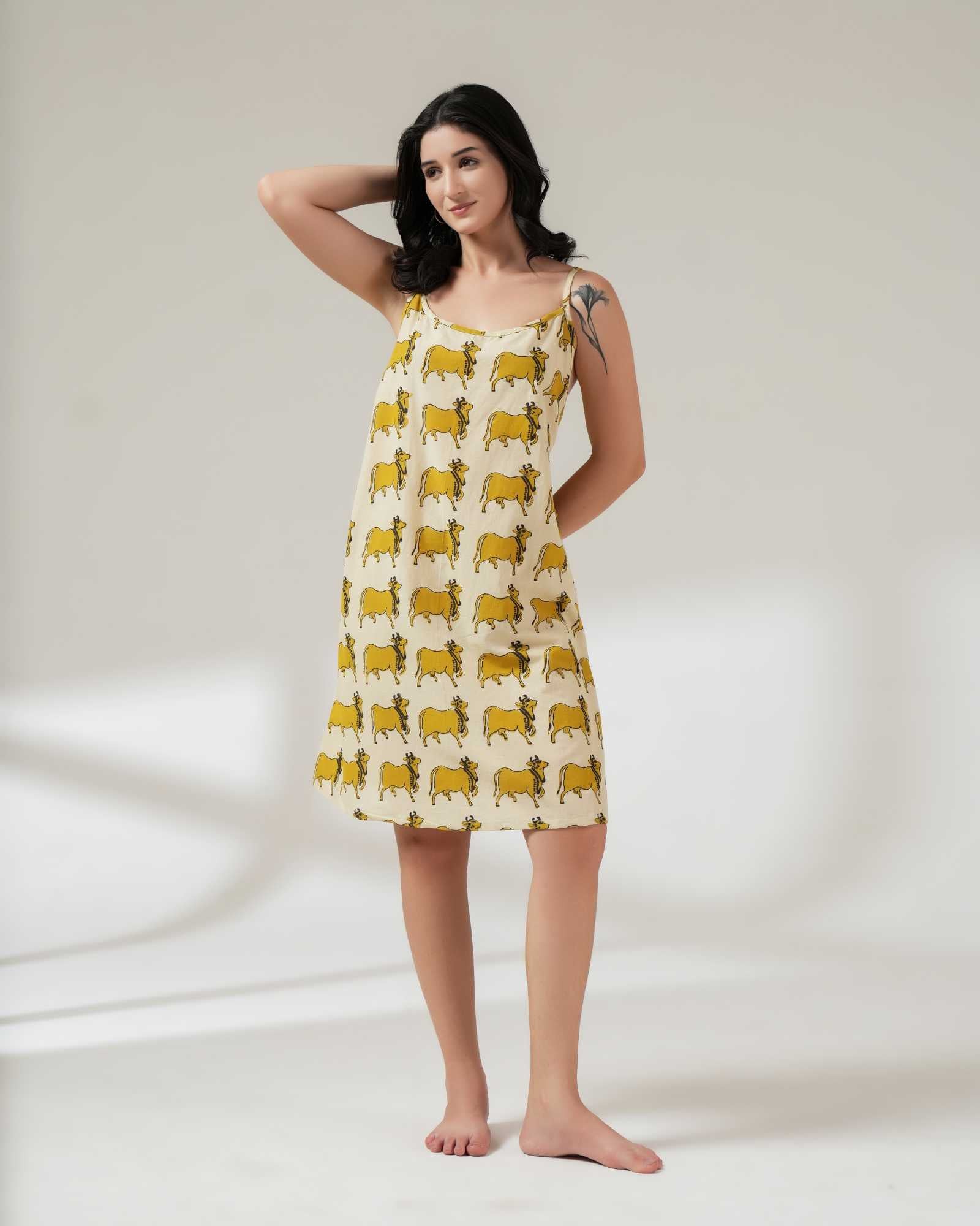 Woman wearing a yellow patterned dress on a white background