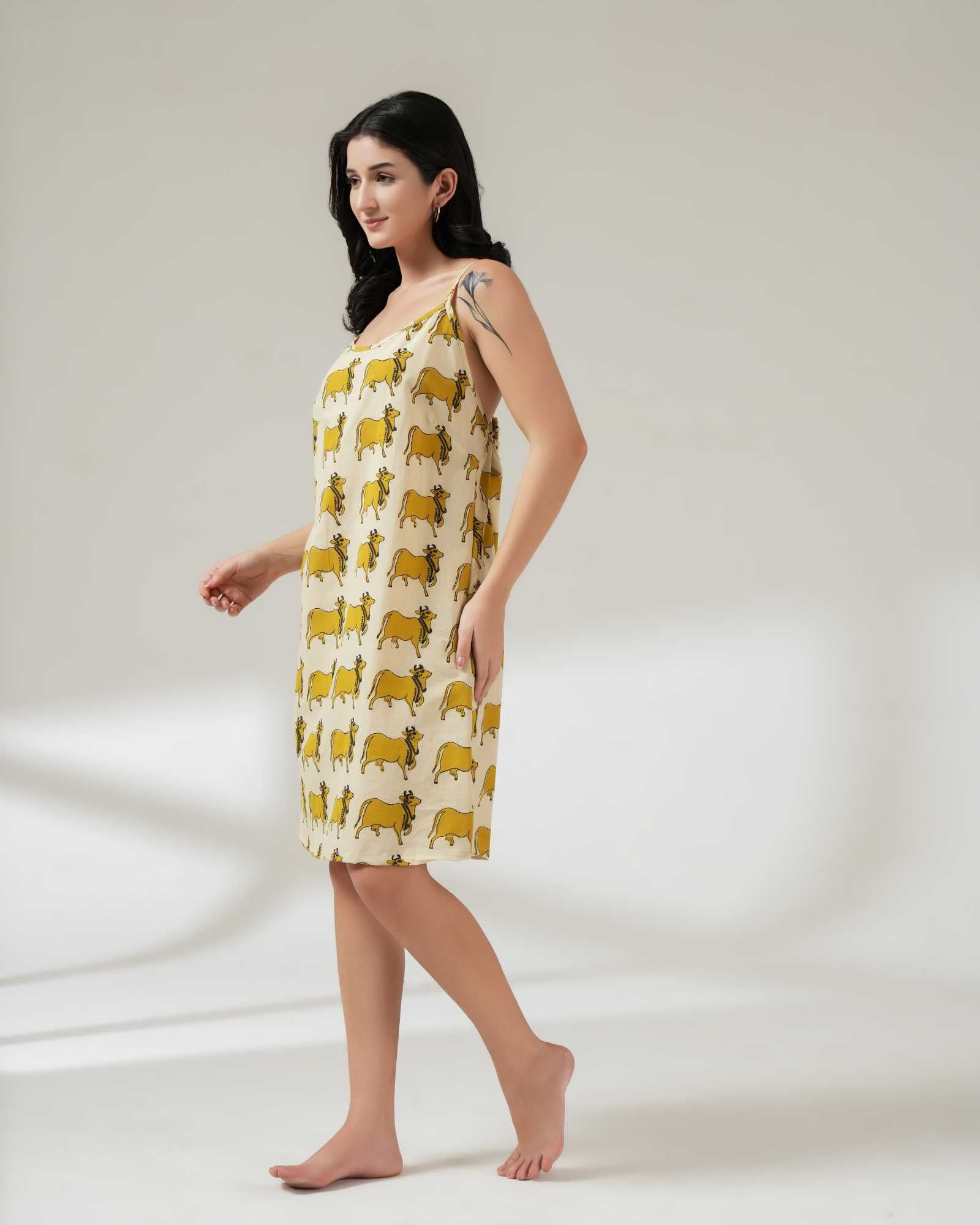 Woman wearing a yellow patterned dress on a white background