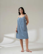 Woman wearing a blue floral dress on a white background