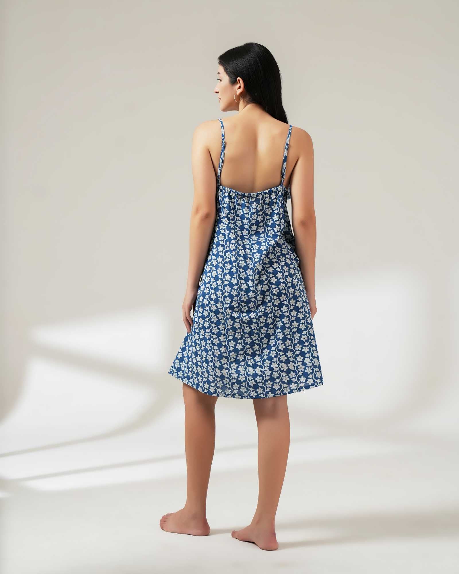 Woman wearing a blue floral dress on a white background