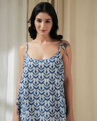 Woman wearing a blue and white patterned dress indoors