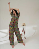 Woman wearing a colorful pajama set on a white background