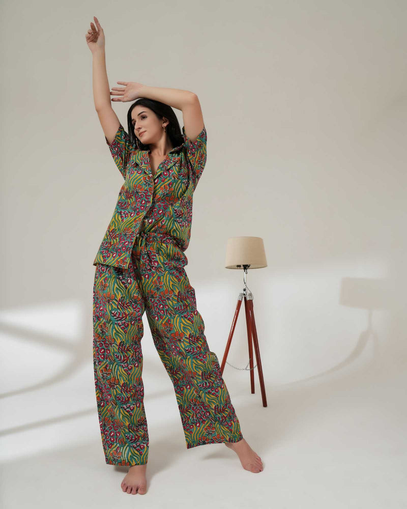 Woman wearing a colorful pajama set on a white background
