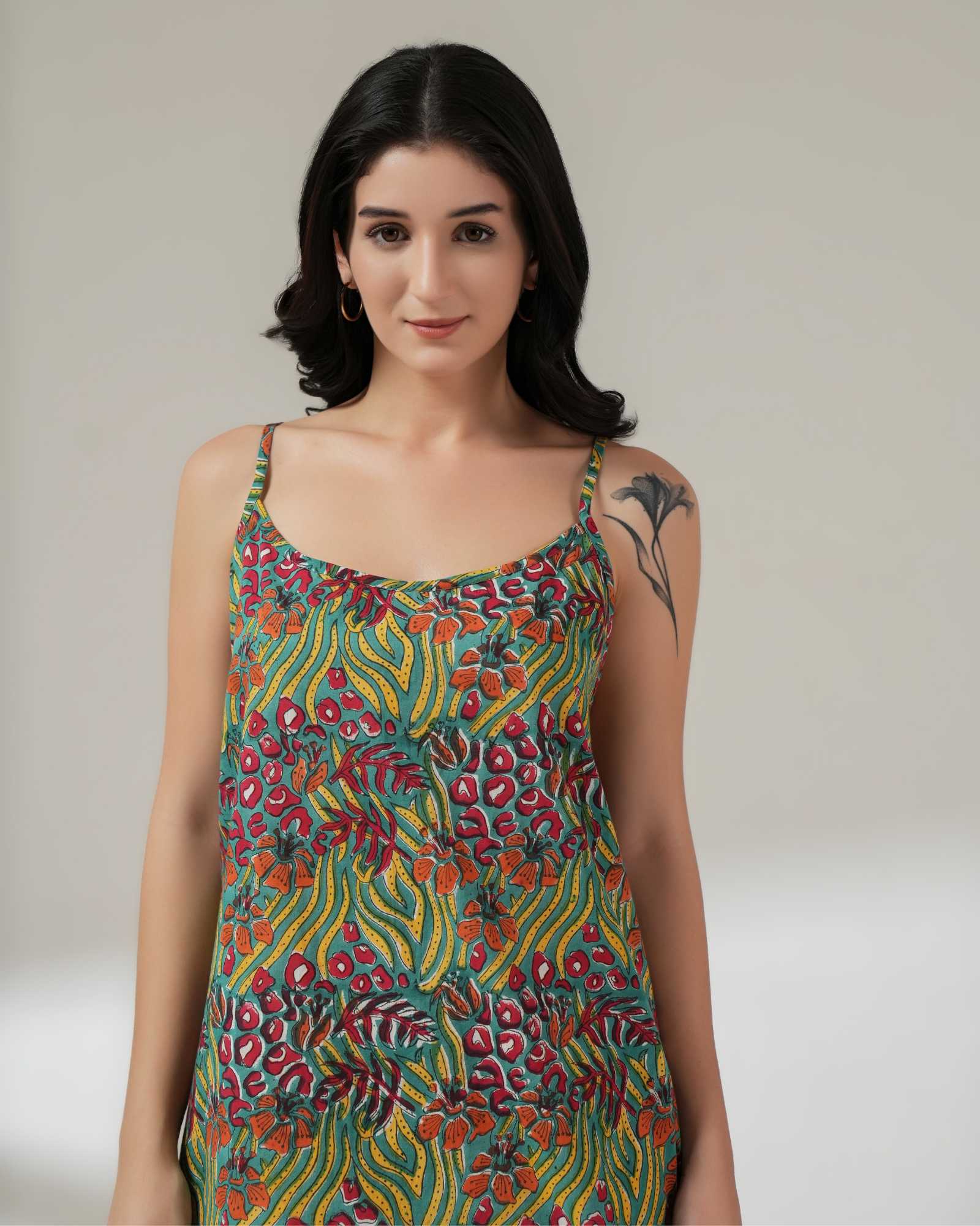 Woman wearing a colorful patterned dress against a plain background