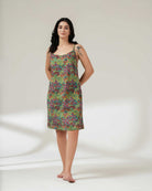 Woman wearing a colorful patterned dress on a white background