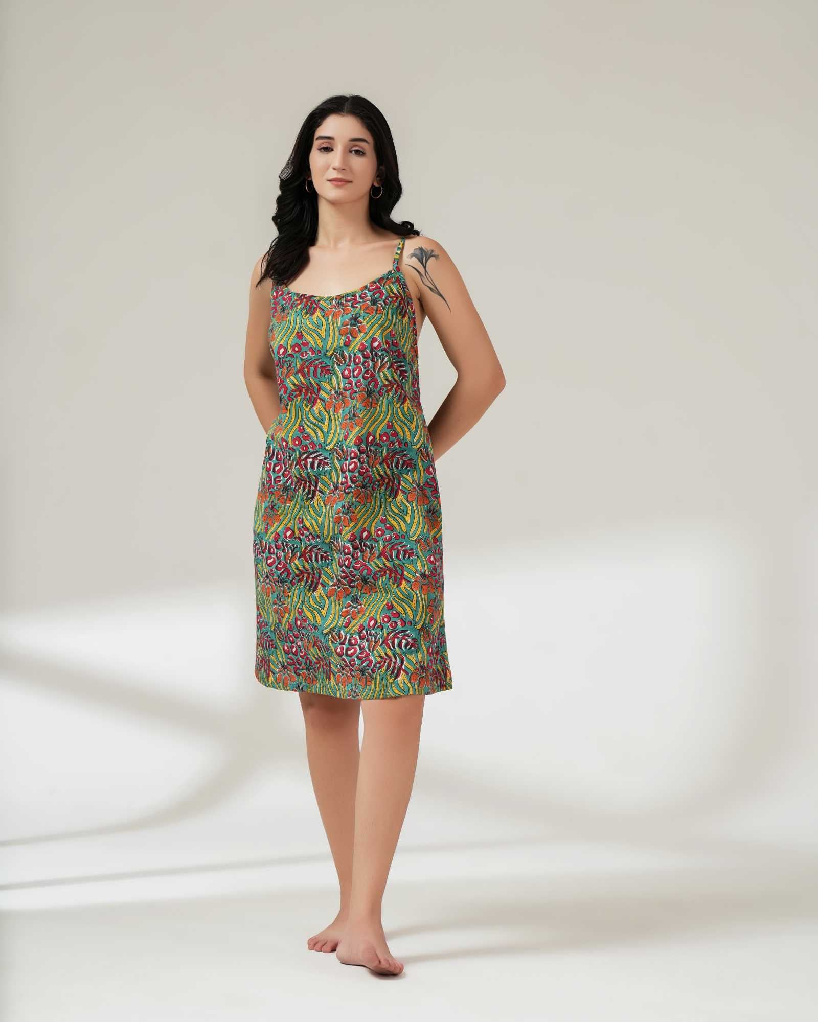 Woman wearing a colorful patterned dress on a white background