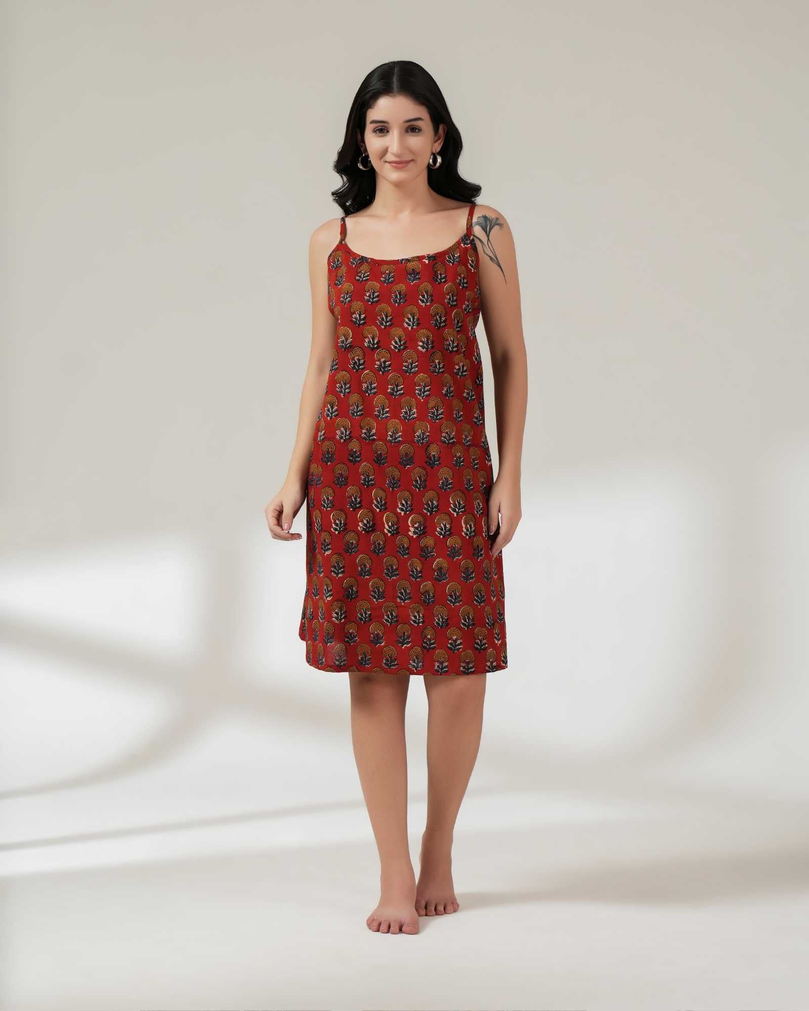 Woman wearing a red patterned dress on a white background