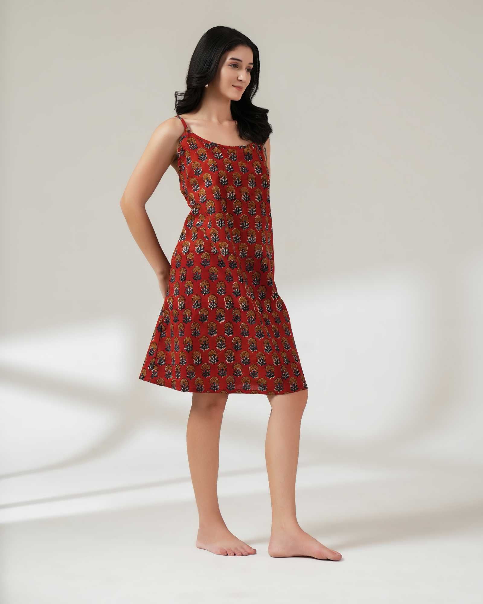 Woman wearing a red patterned dress on a white background