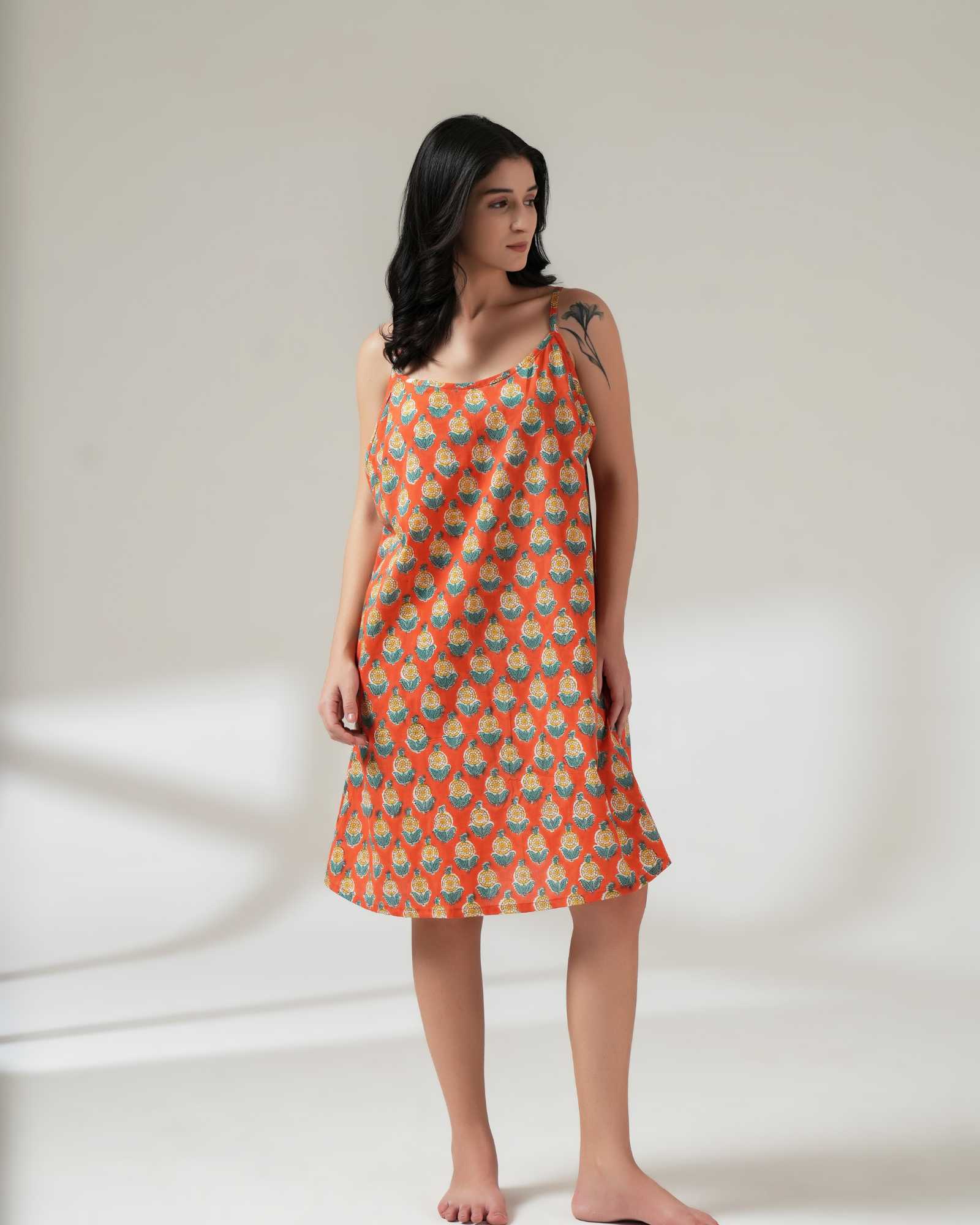 Woman wearing a patterned dress on a plain background