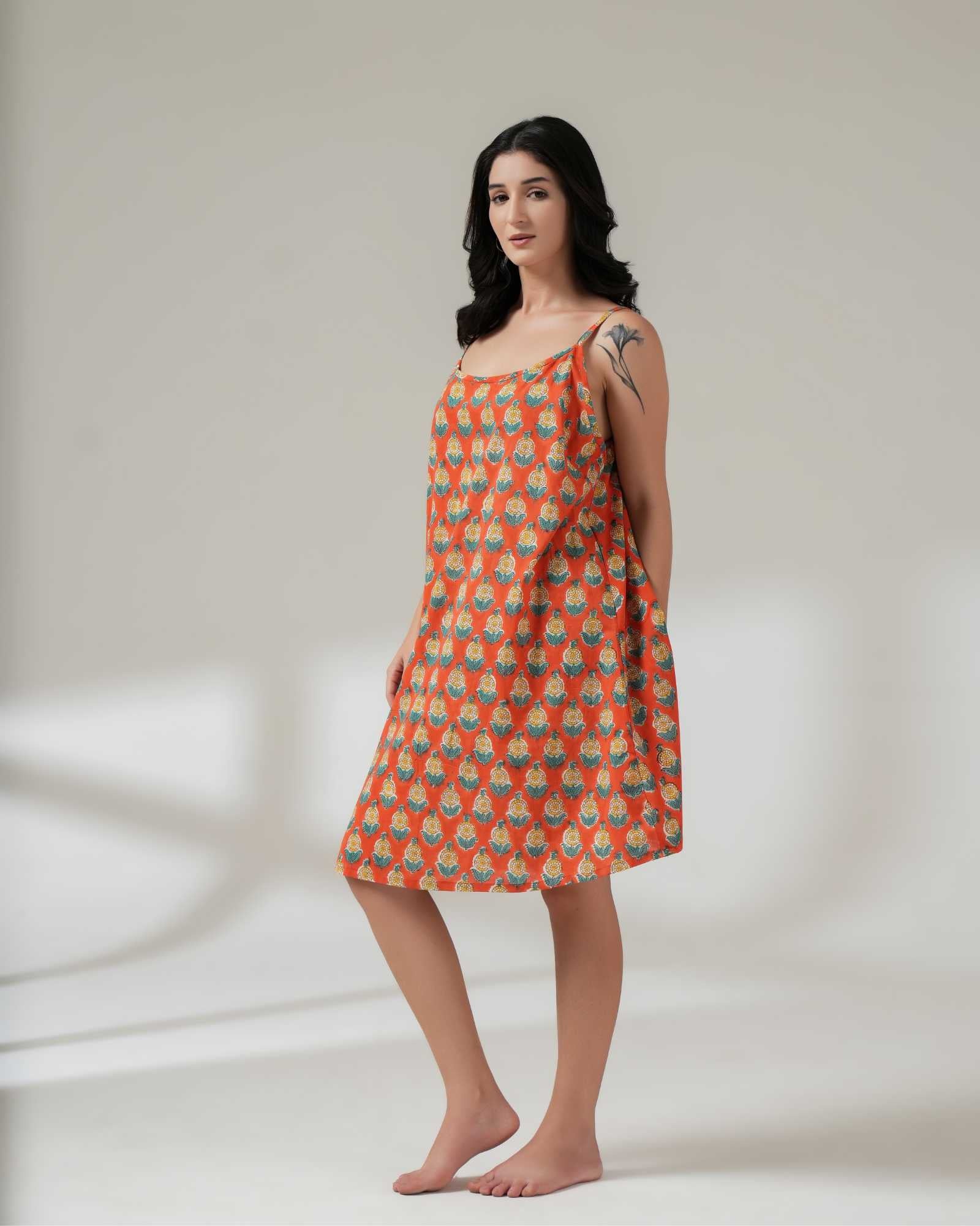 Woman wearing a patterned dress on a plain background