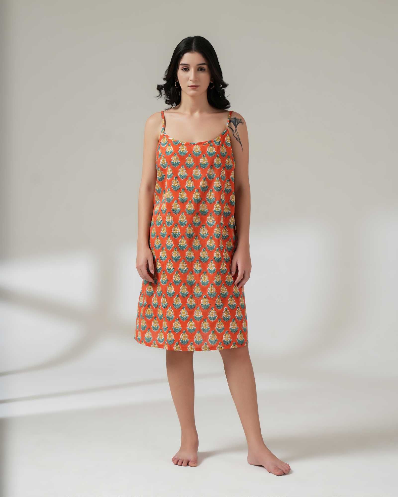 Woman wearing a patterned dress on a plain background