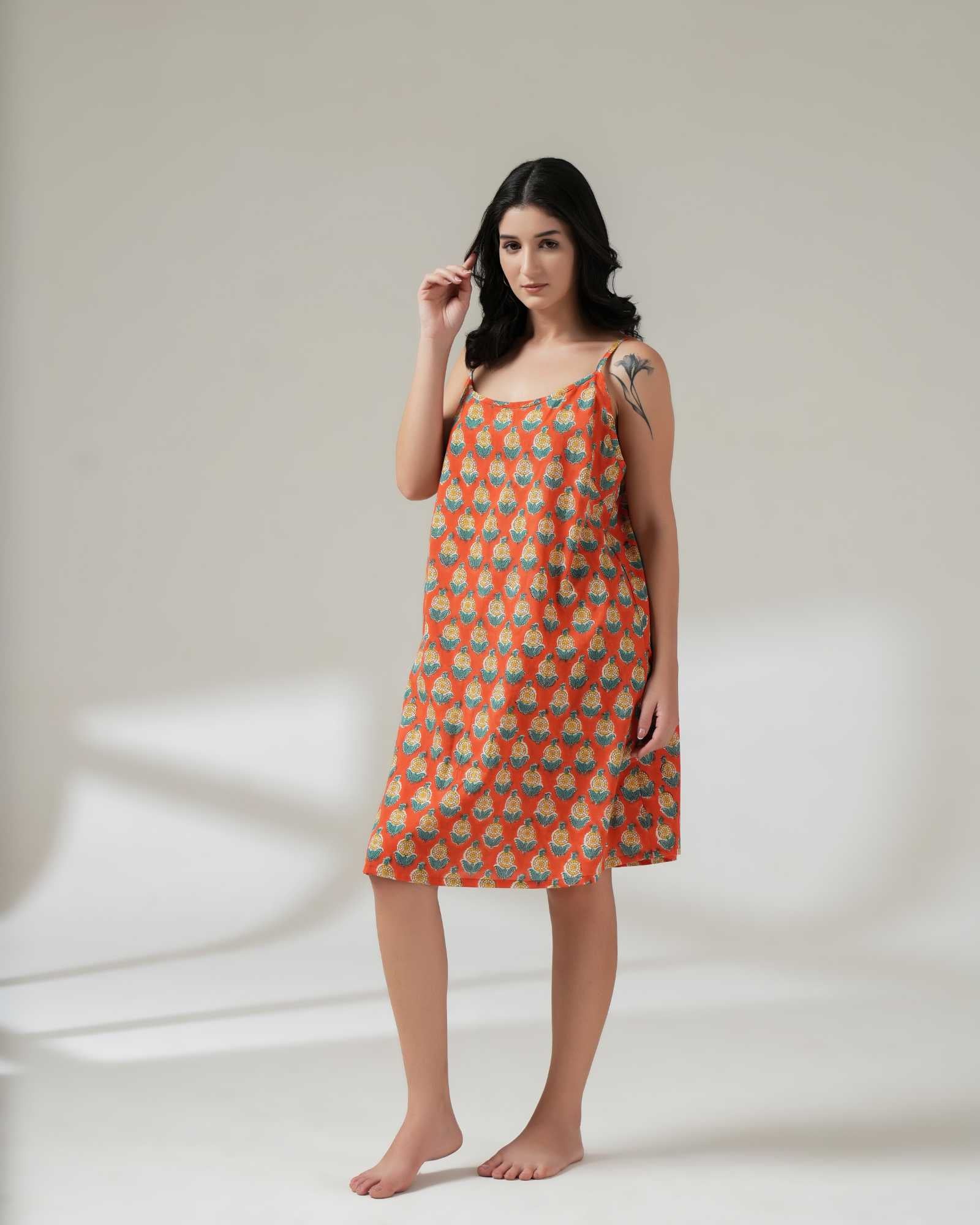 Woman wearing a patterned dress on a plain background