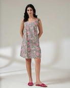 Woman wearing a floral dress on a plain background