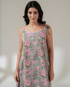 Woman wearing a floral dress with a plain background