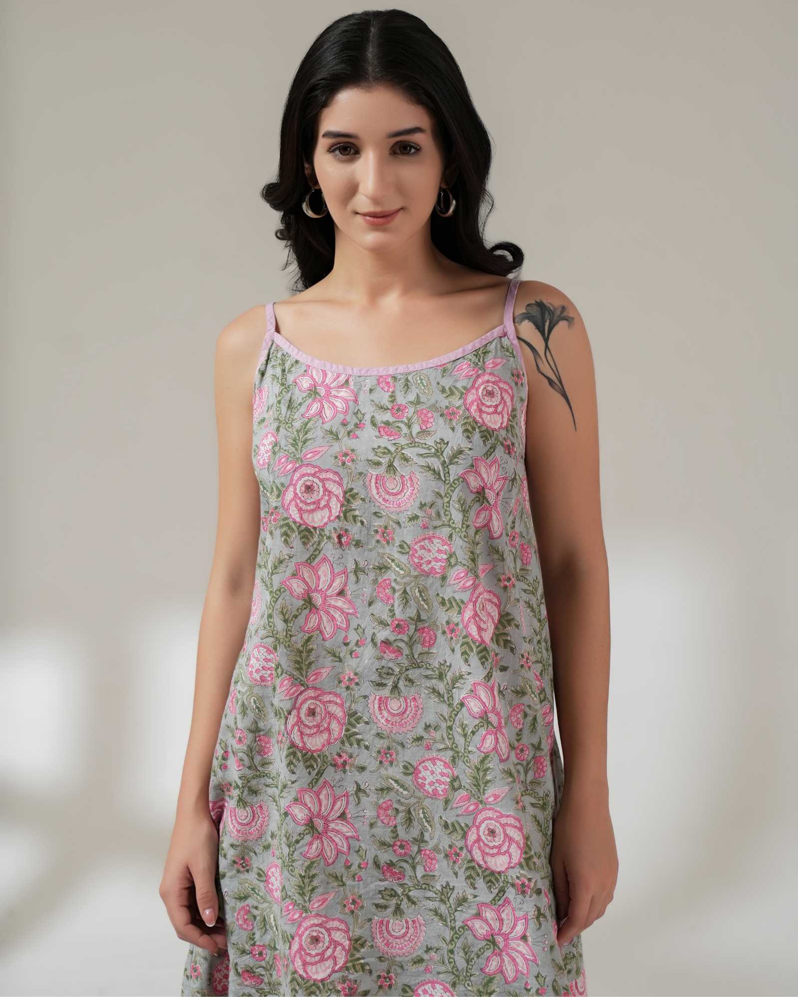 Woman wearing a floral dress with a plain background
