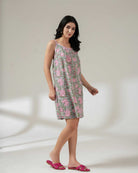 Woman wearing a floral dress on a plain background