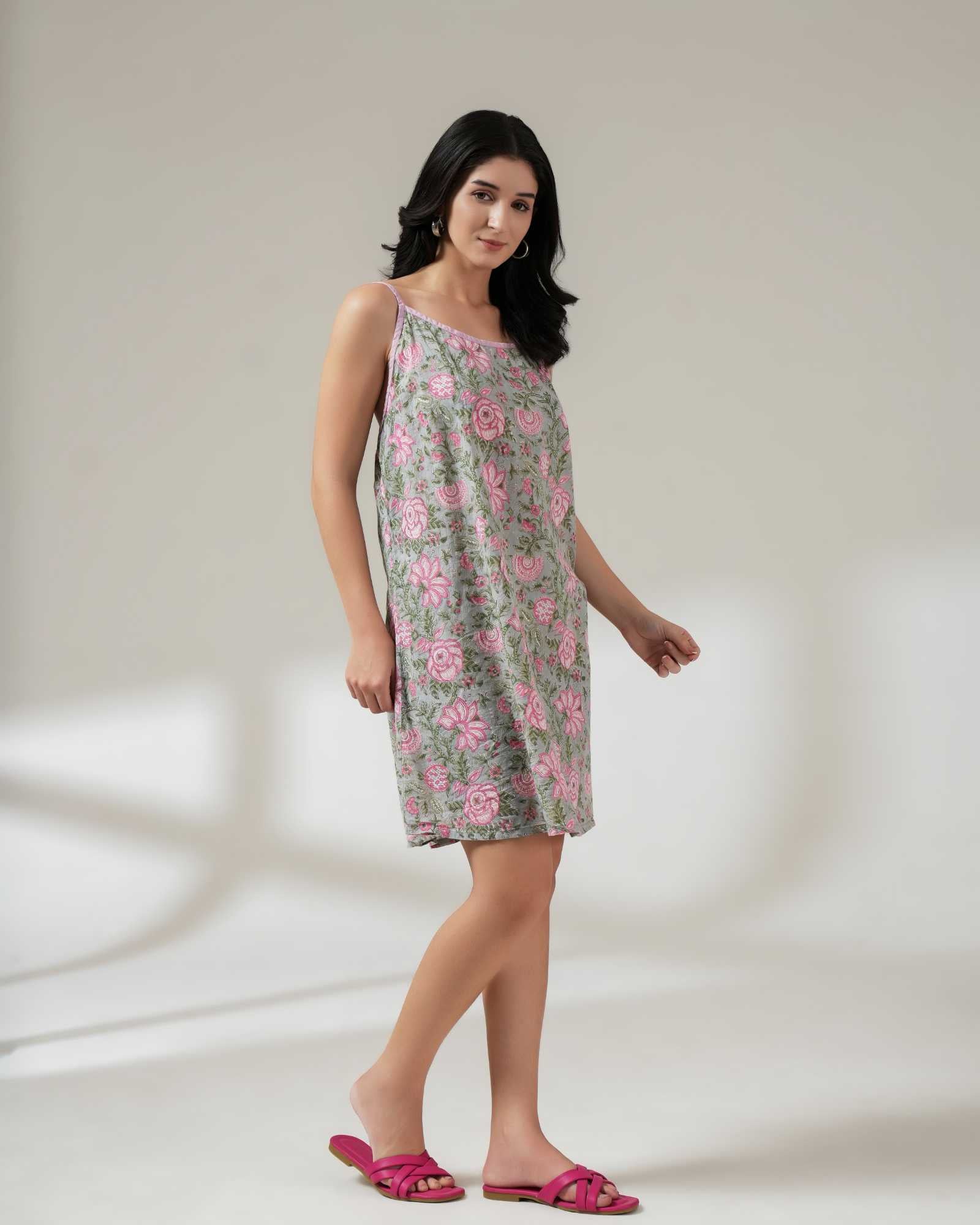Woman wearing a floral dress on a plain background
