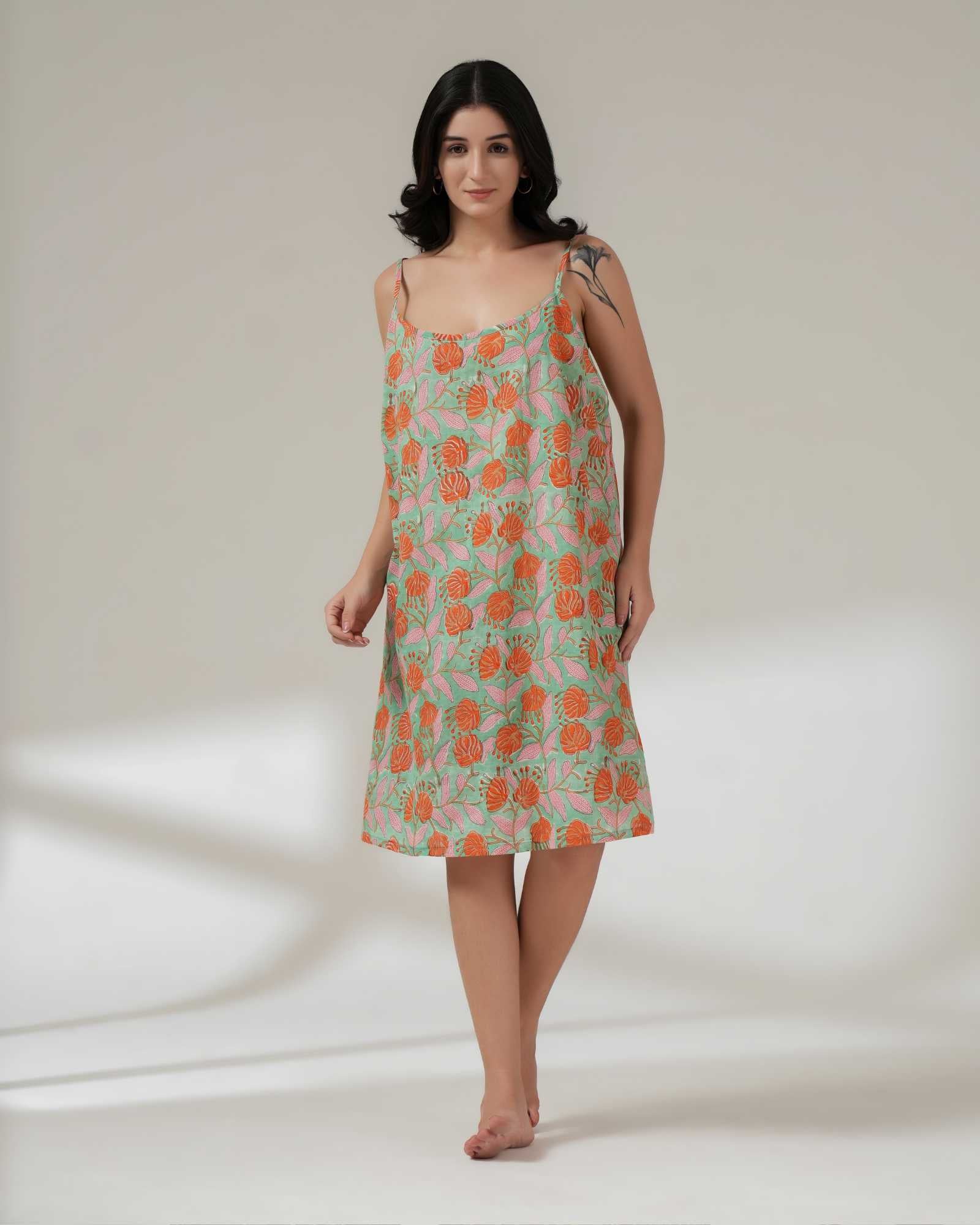 Woman wearing a floral dress on a plain background
