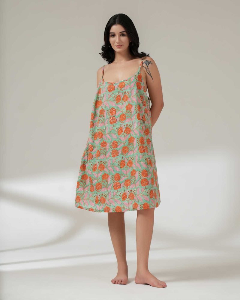 Woman wearing a floral dress on a plain background