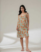 Woman wearing a floral dress on a plain background