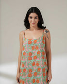 Woman wearing a floral dress with a neutral background
