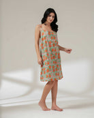 Woman wearing a floral dress on a plain background