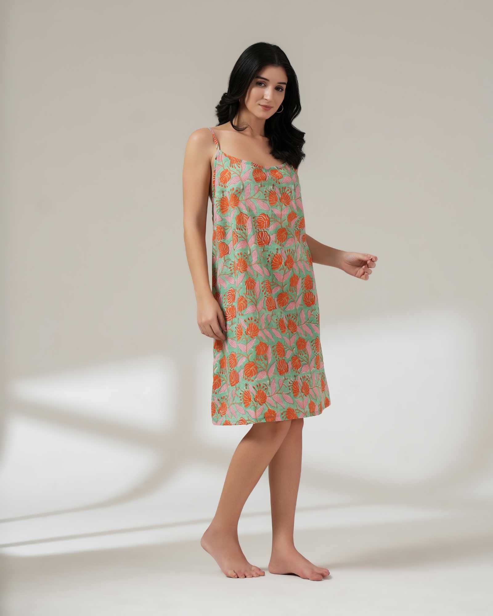 Woman wearing a floral dress on a plain background