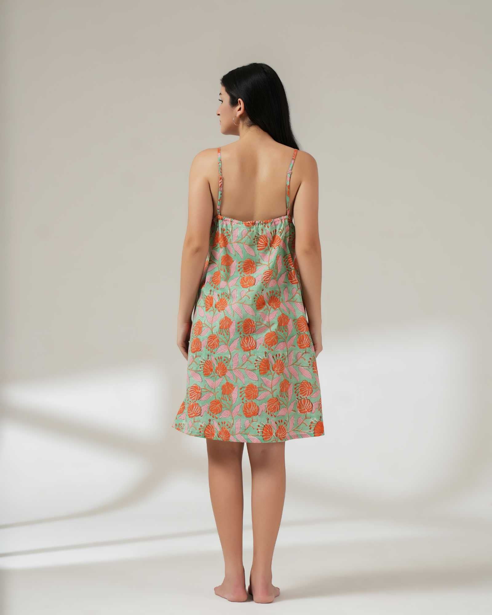 Woman wearing a floral dress on a plain background