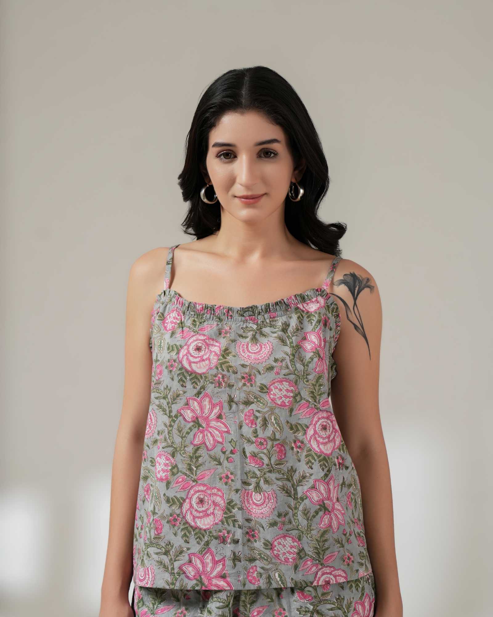 Woman wearing a floral top with a plain background